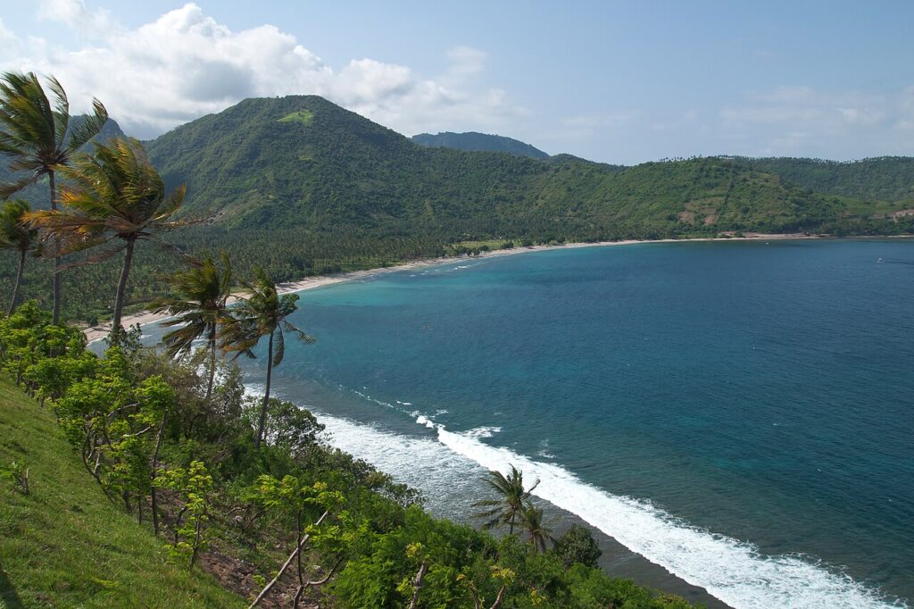 A sandy bay on Lombok framed by green coastal headlands